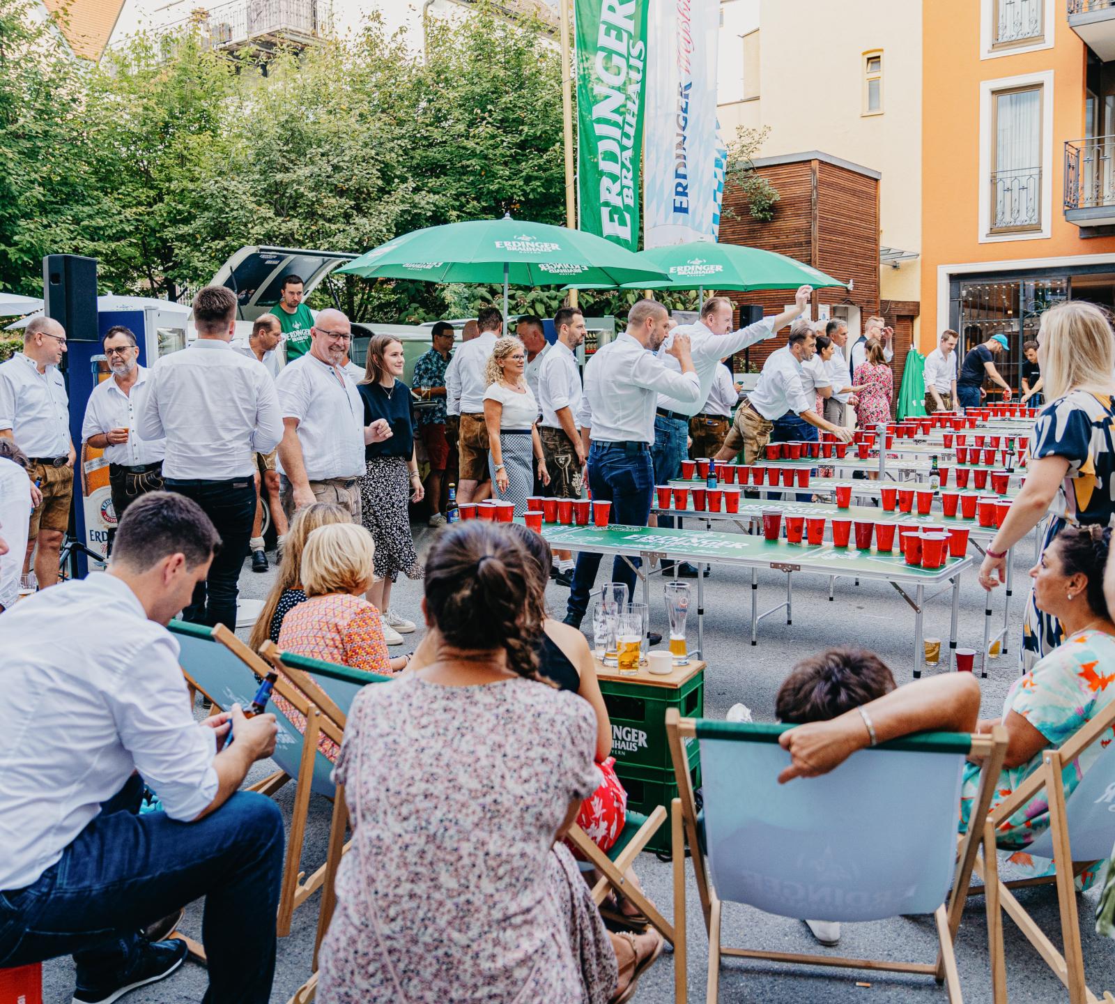 Audience of ERDINGER employees at a beer pong company event.