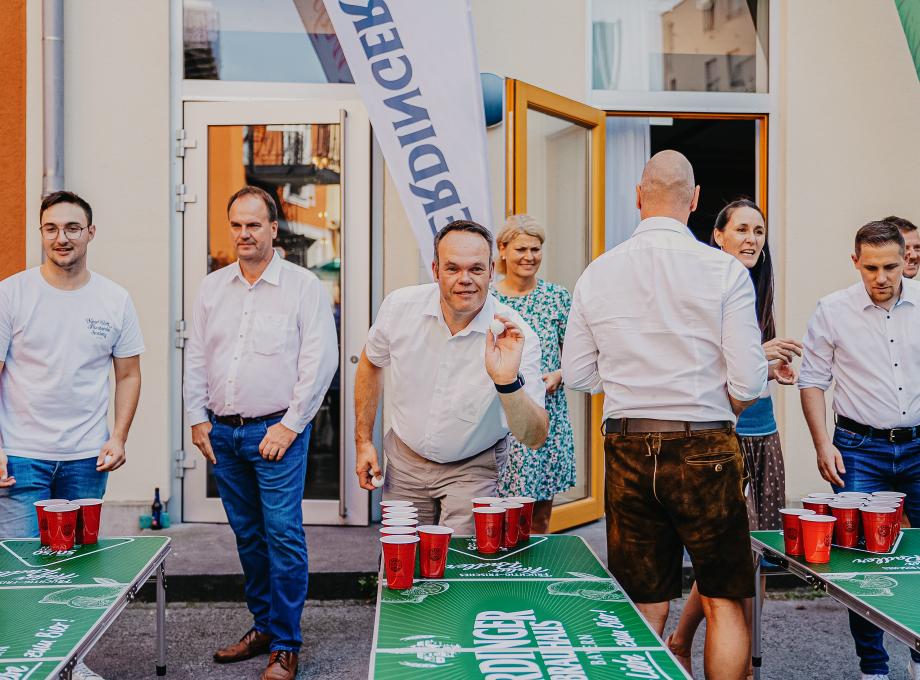 ERDINGER sales representatives are playing beer pong.