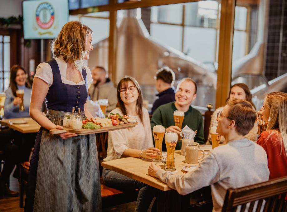 The staff serves snacks to a sociable group at the ERDINGER Visitor Center.