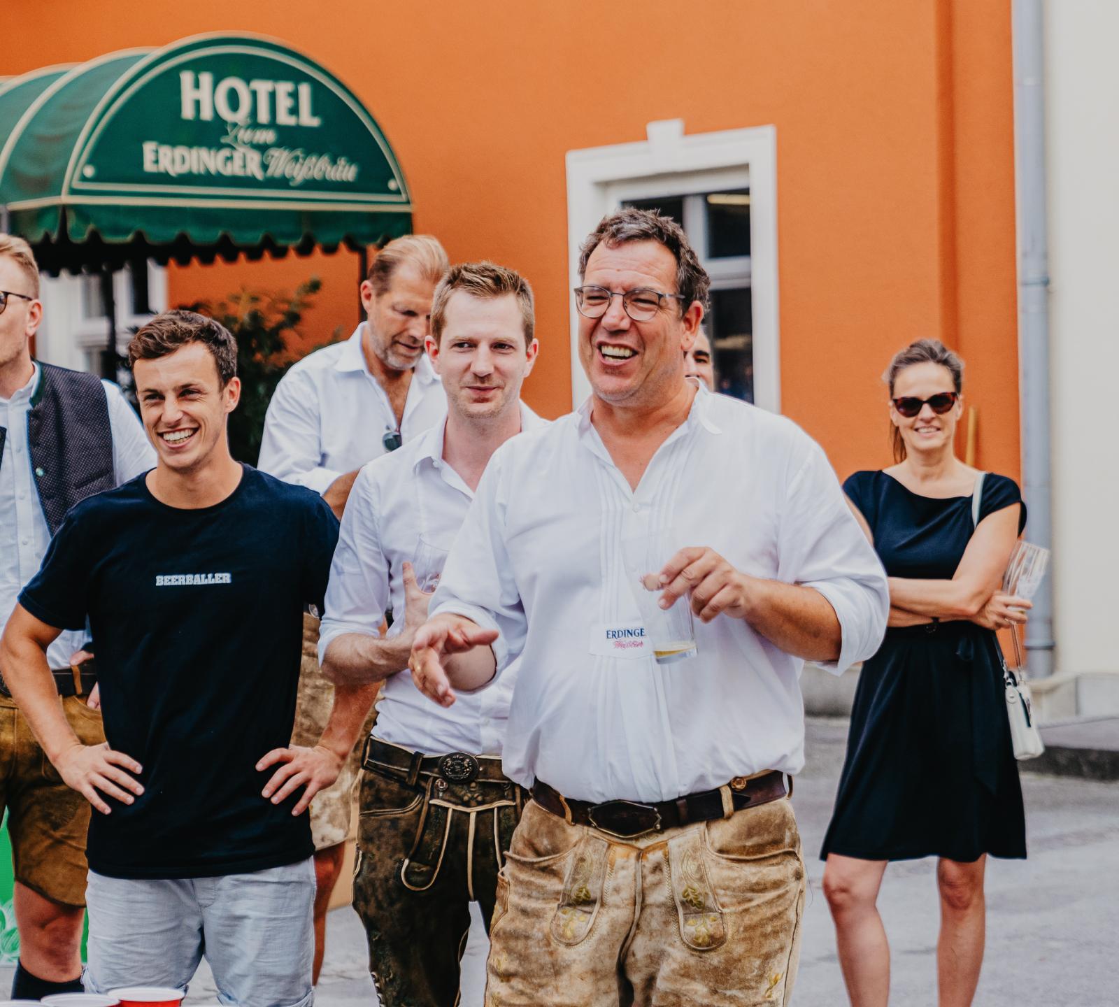 ERDINGER employees watch their colleagues play beer pong.
