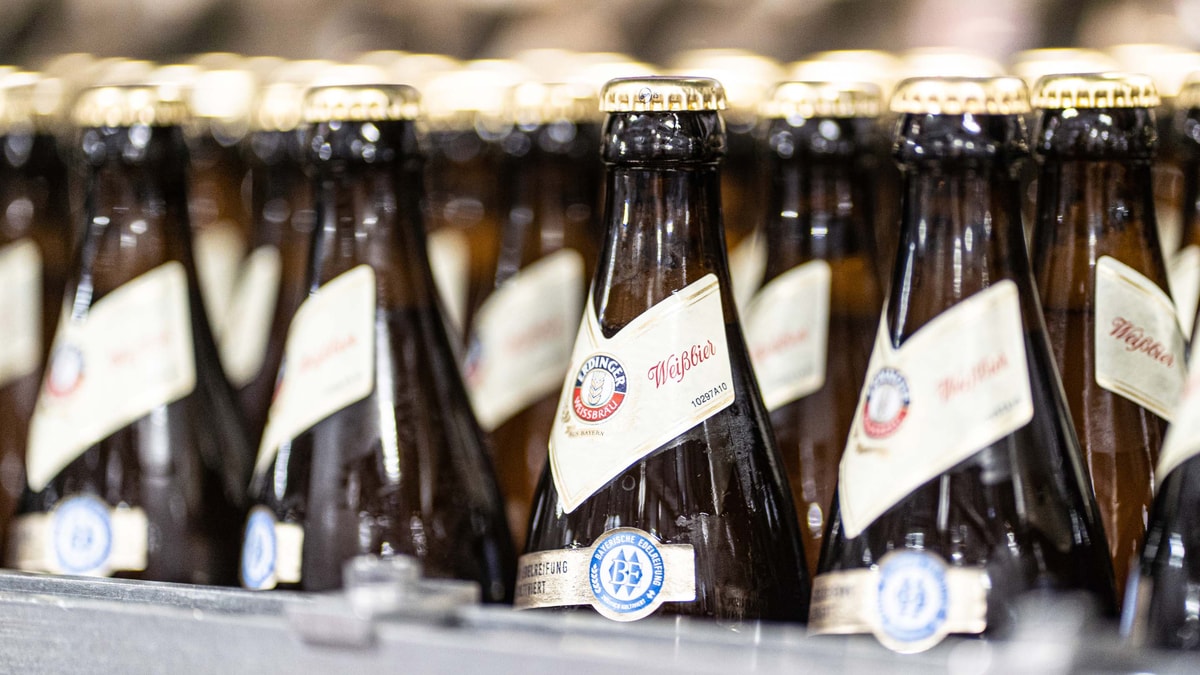 Close-up of many ERDINGER wheat beer bottles with the Bavarian "Edelreifung" label.
