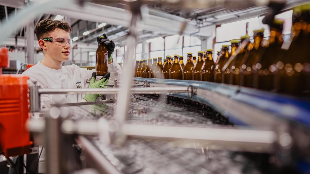 Two brewers are taking a beer sample of ERDINGER Brauhaus Helles.