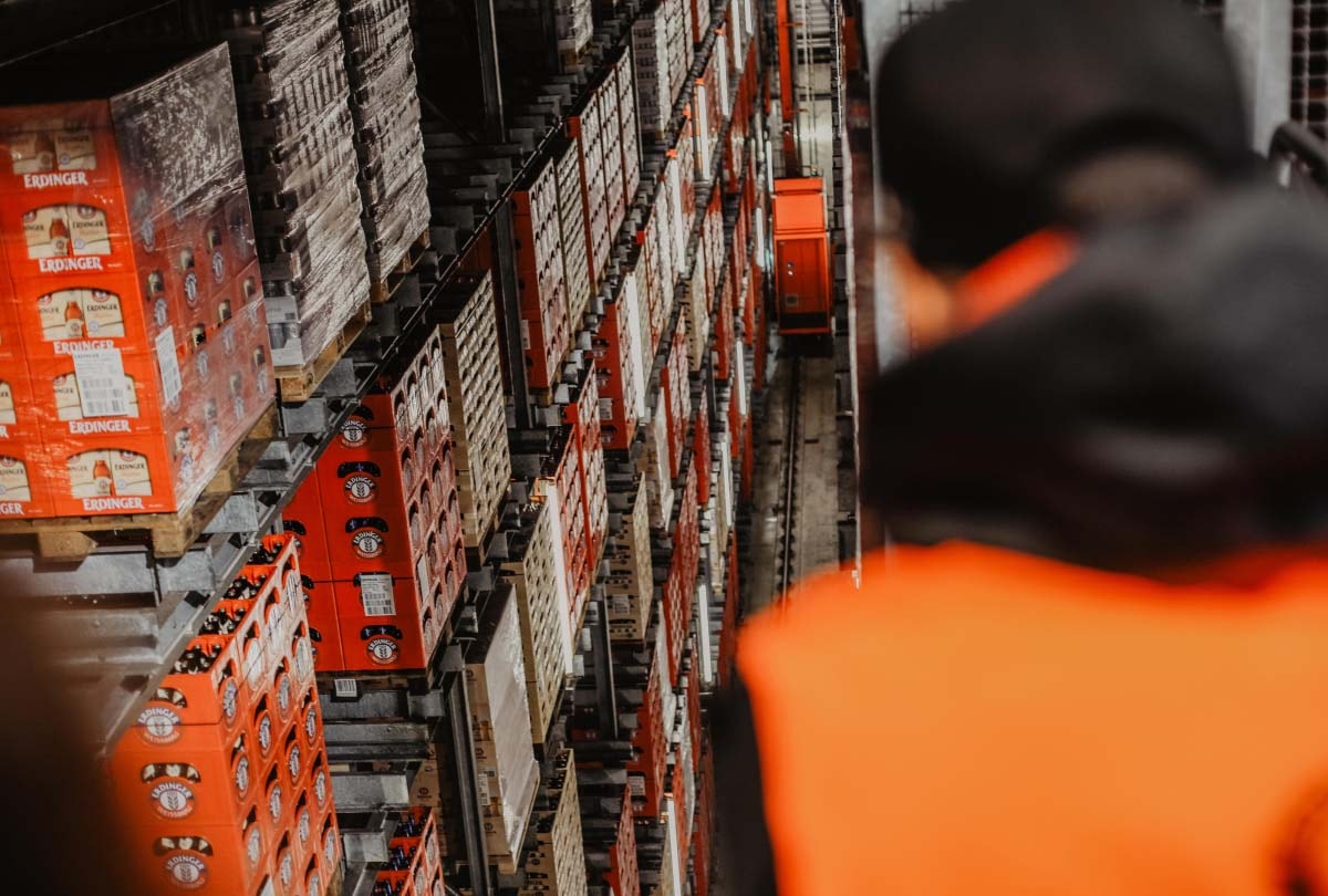 Stacked beer crates in the ERDINGER high-bay warehouse.